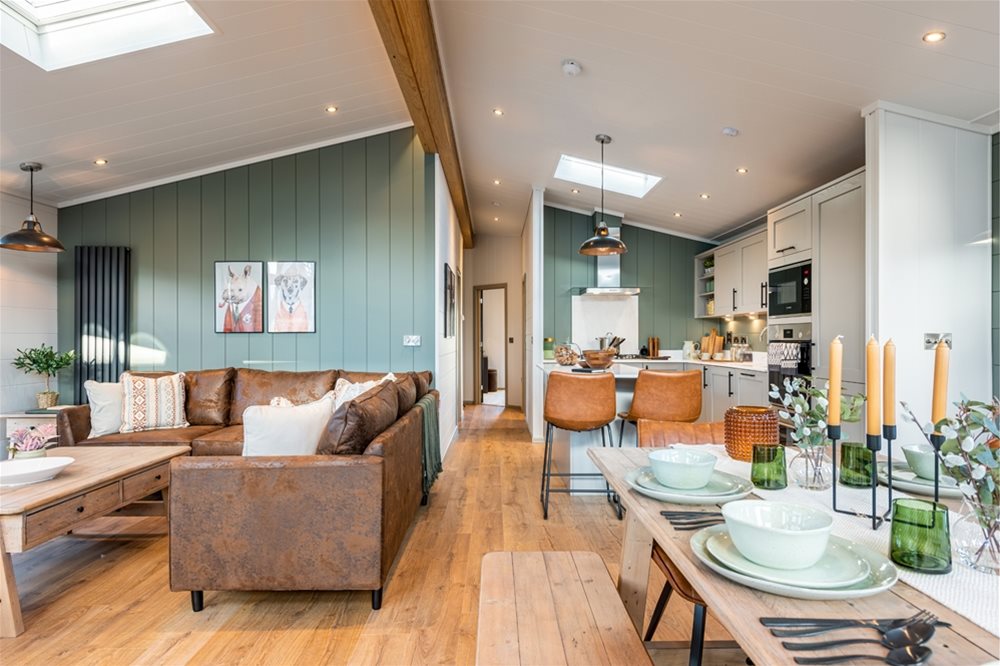 Modern open-plan holiday lodge interior with kitchen, dining, and living space designed for comfort and style. multi-brand manufacturing strategy