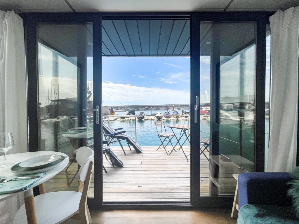 View from a floating home overlooking marina pontoons and boats, showing new revenue opportunities for marinas. diversify marina revenue